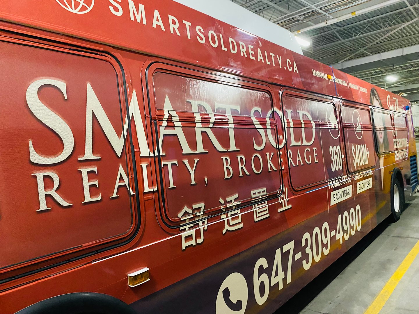 Another side view of the Smart Sold Realty Full Side bus advertisement with Sue Zhang’s portrait and business phone number.